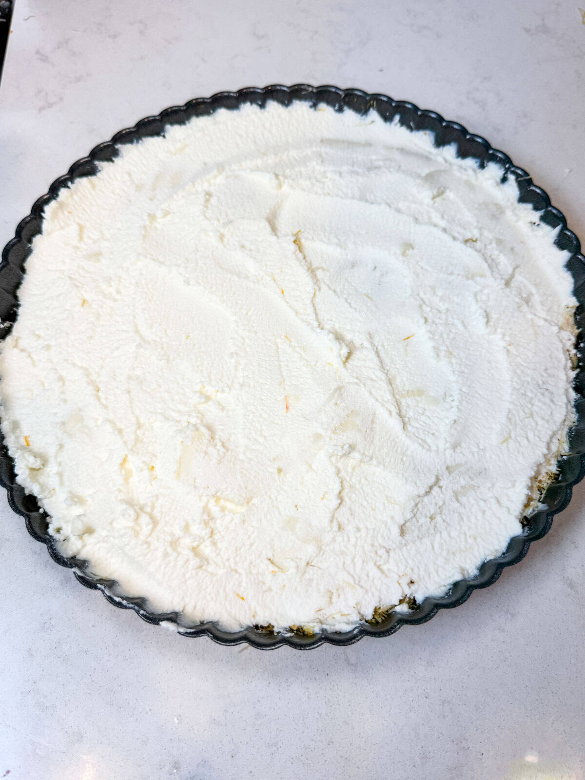 Layer the sliced mozzarella and spread the ricotta cheese on top of the shredded phyllo.