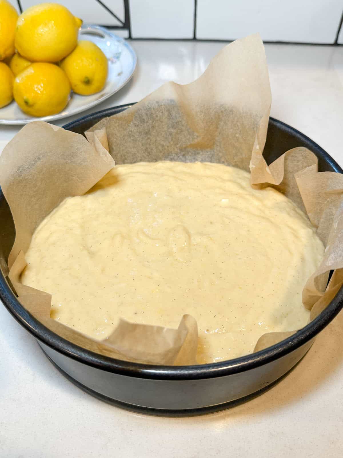 Pour the lemon cake batter into a cheesecake pan lined with parchment paper.
