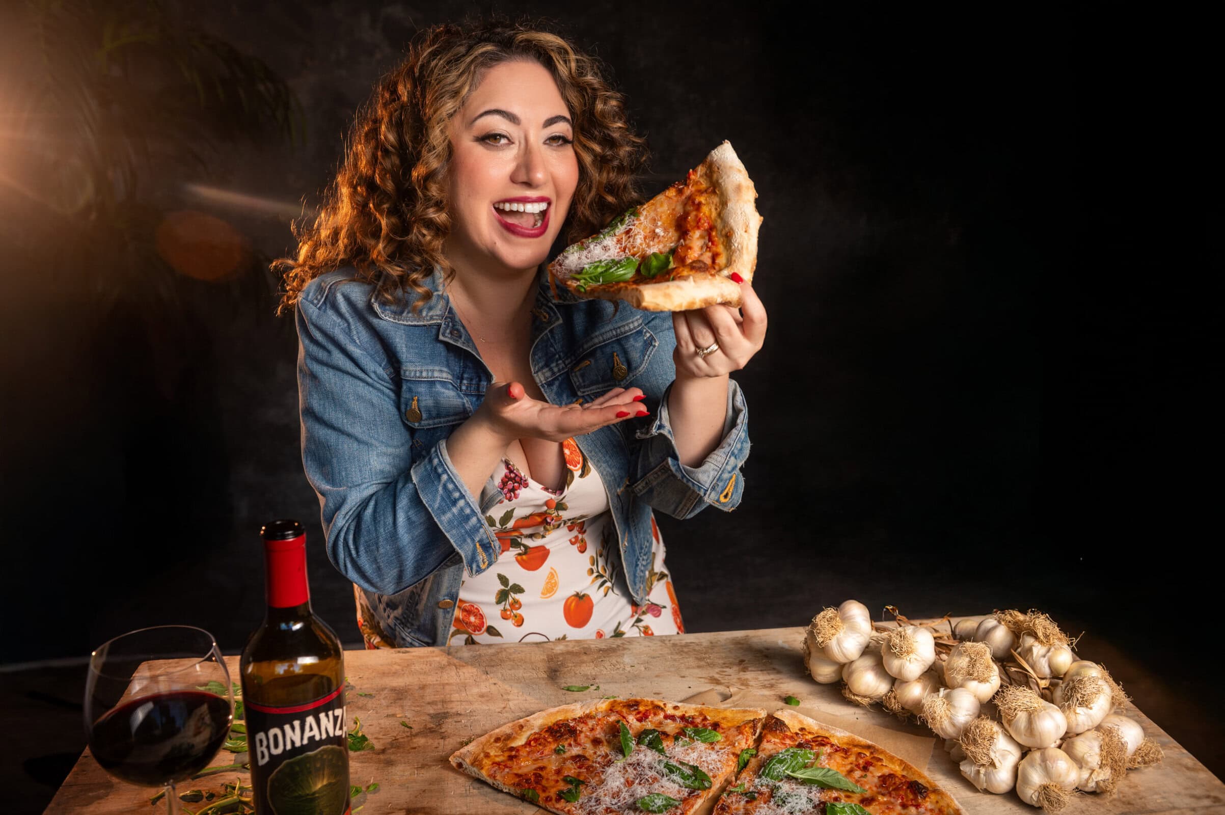 Samantha Ferraro headshot eating pizza.