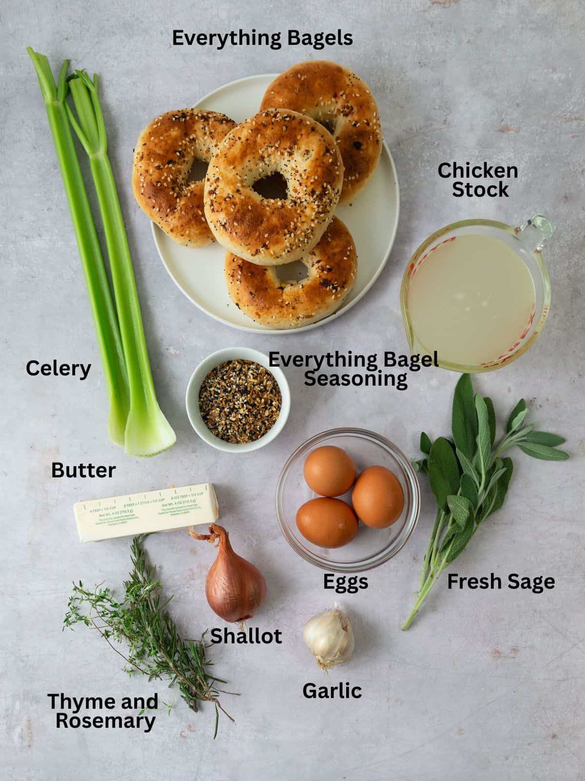 Ingredients for everything spiced bagel stuffing with everything bagels, butter, savory herbs, celery and garlic.