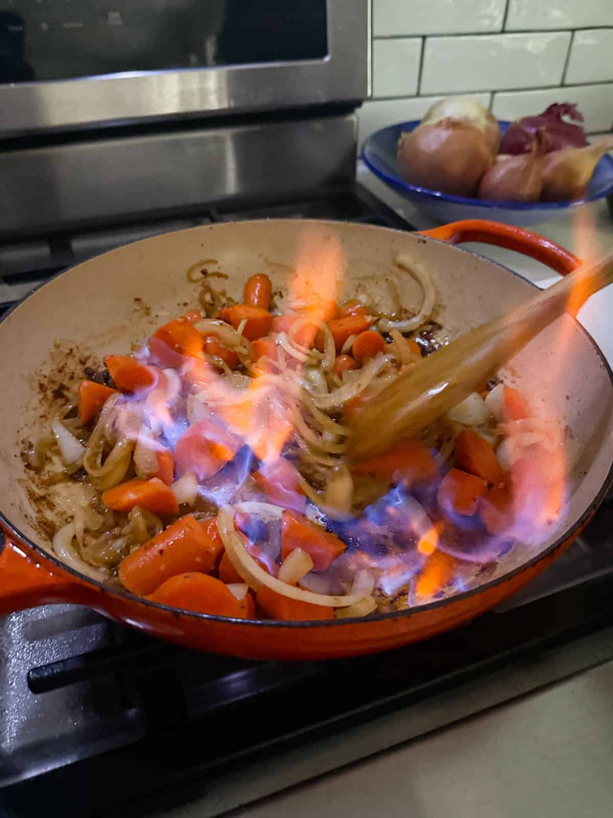 Pour in the cognac (and carefully flambé if you’d like!), then add the red wine and scrape up the browned bits from the pan. Let the wine reduce slightly before moving on.