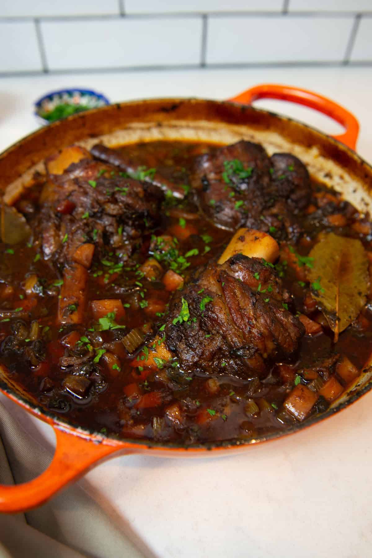 Greek style braised lamb shanks with cinnamon, herbs and red wine.