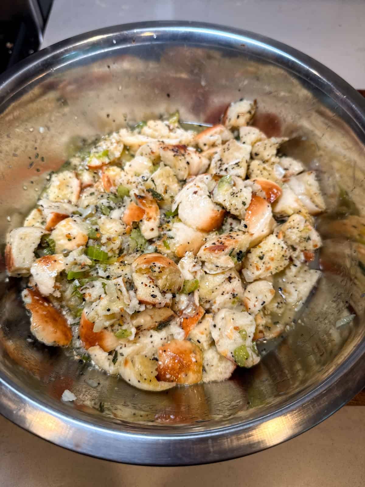 Mix the sauteed vegetables and herbs with the toasted everything bagel cubes.