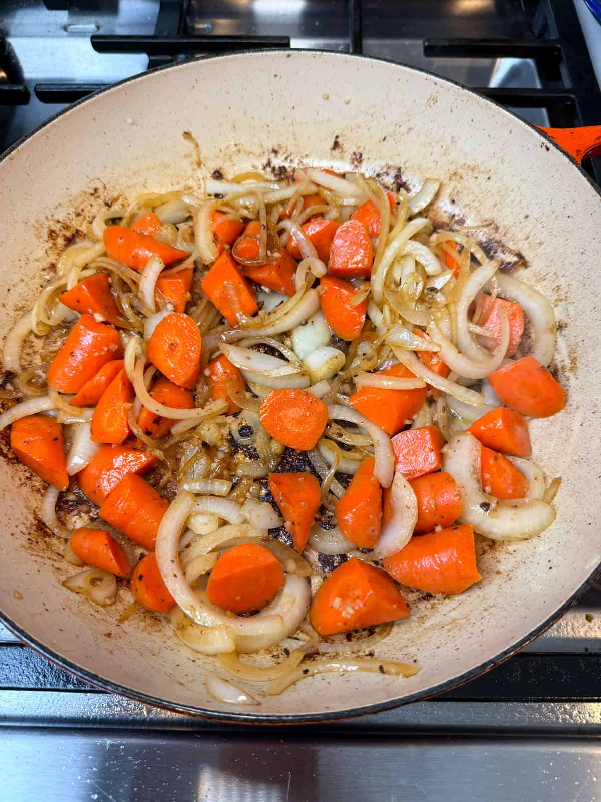 Cook the onions, carrots, and garlic until softened and lightly golden. This builds a flavorful foundation for the sauce.