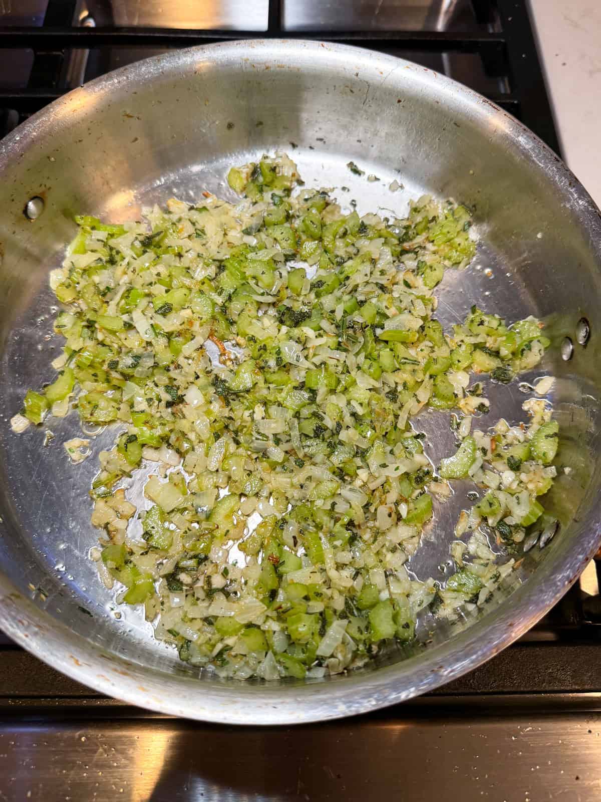Saute the chopped onion, chopped celery and herbs in olive oil.