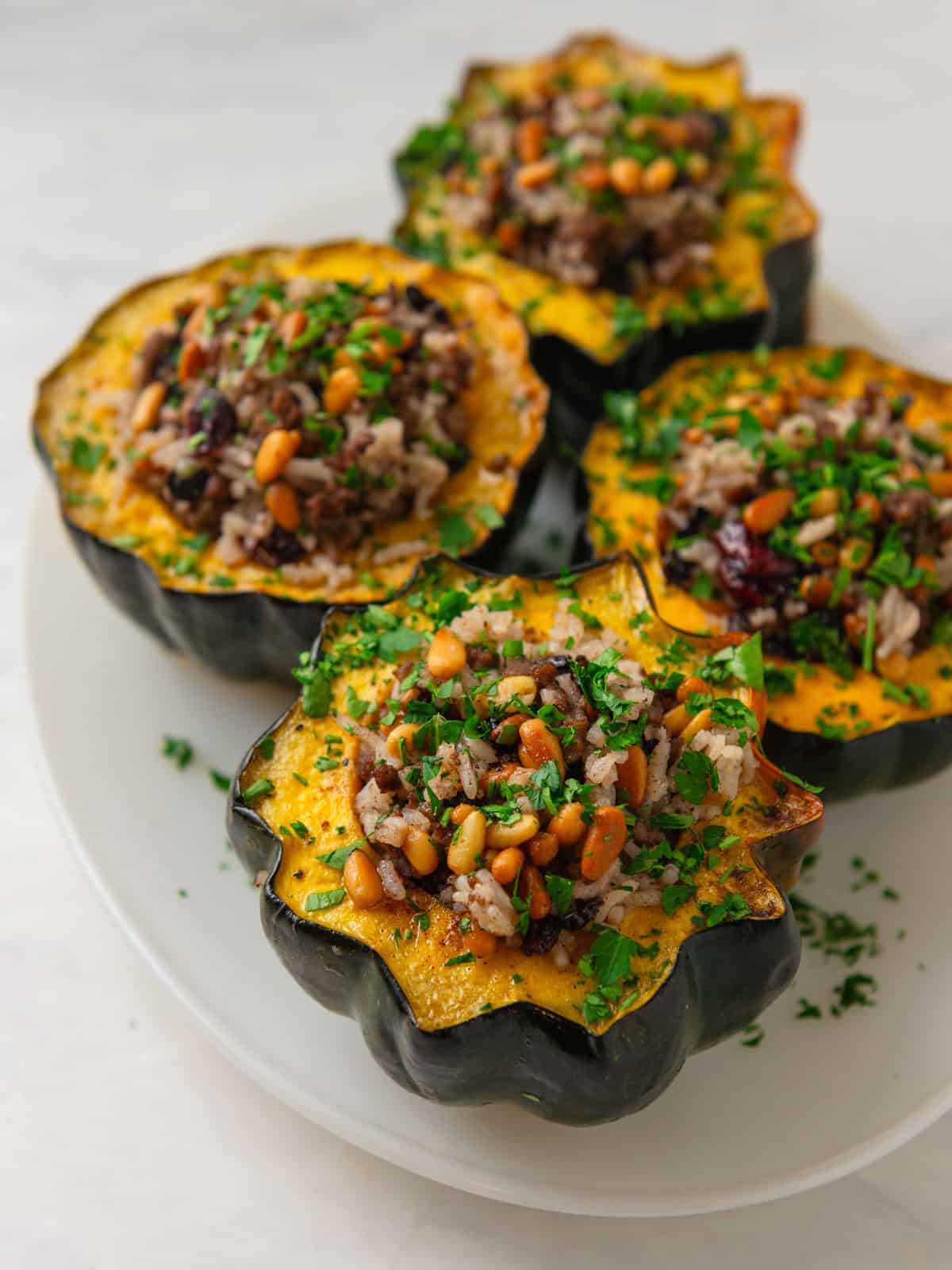 Fill the beef and rice mixture into the acorn squash halves and continue baking until squash is cooked through.