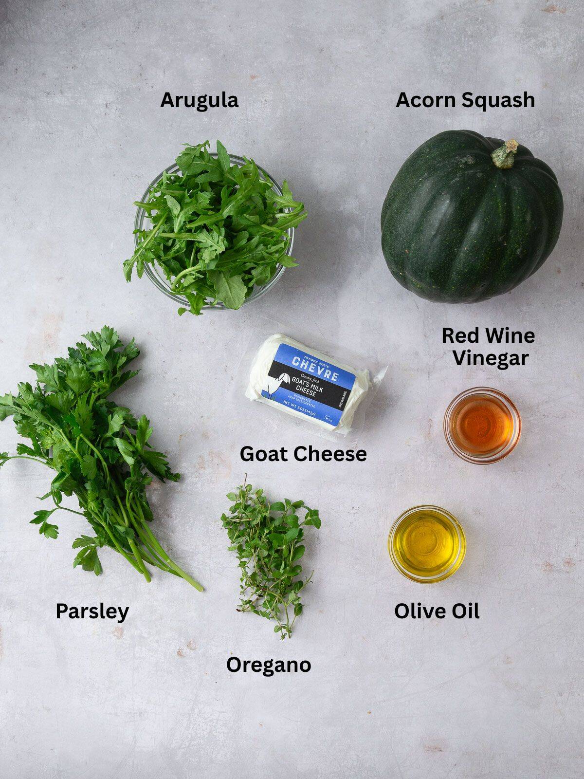 Ingredients for roasted squash with arugula and parsley chimichurri, including goat cheese and red wine vinegar.