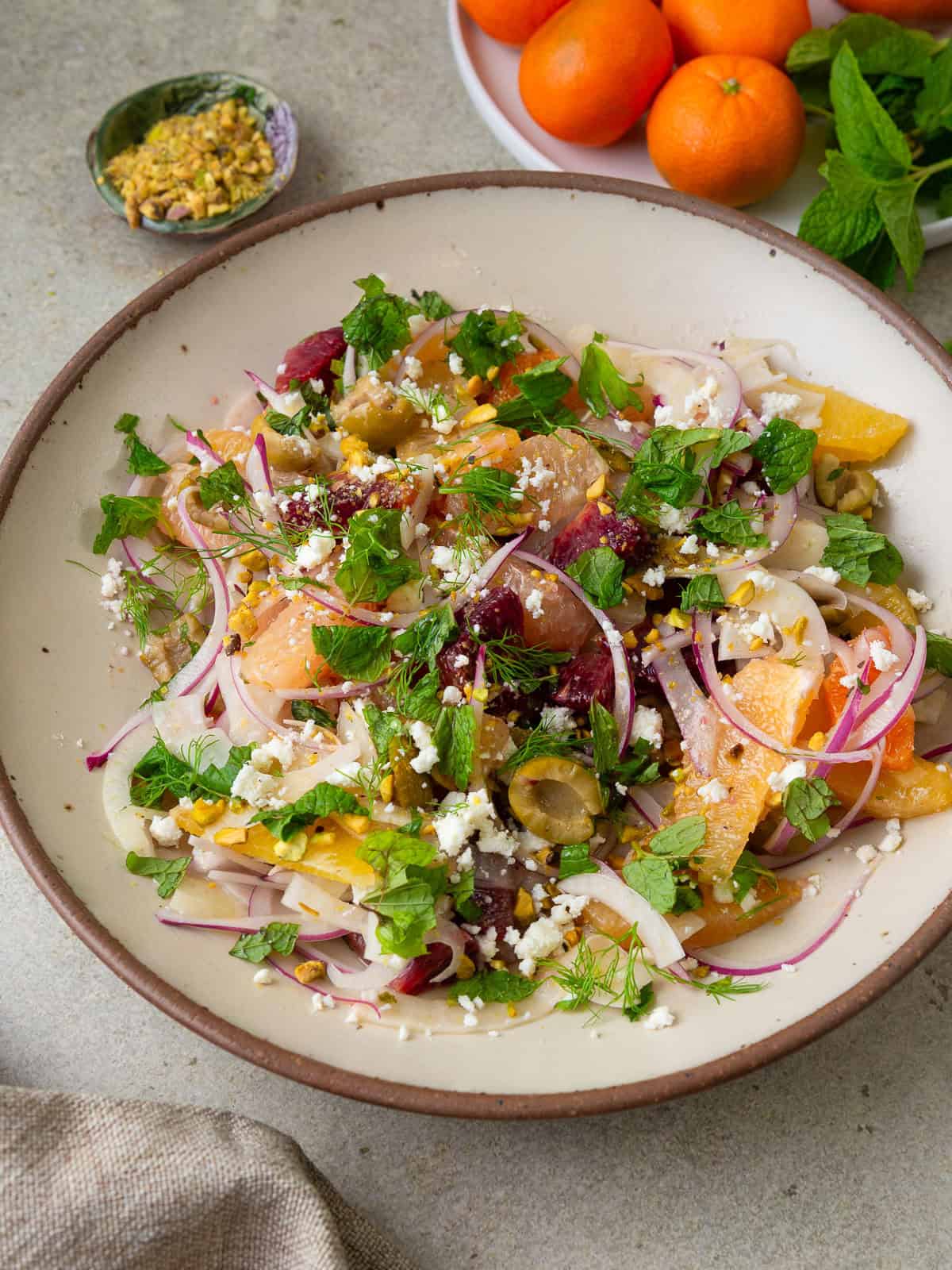 Citrus fennel salad with fresh mint, olives, chopped pistachios and dressed in a tangy vinaigrette.