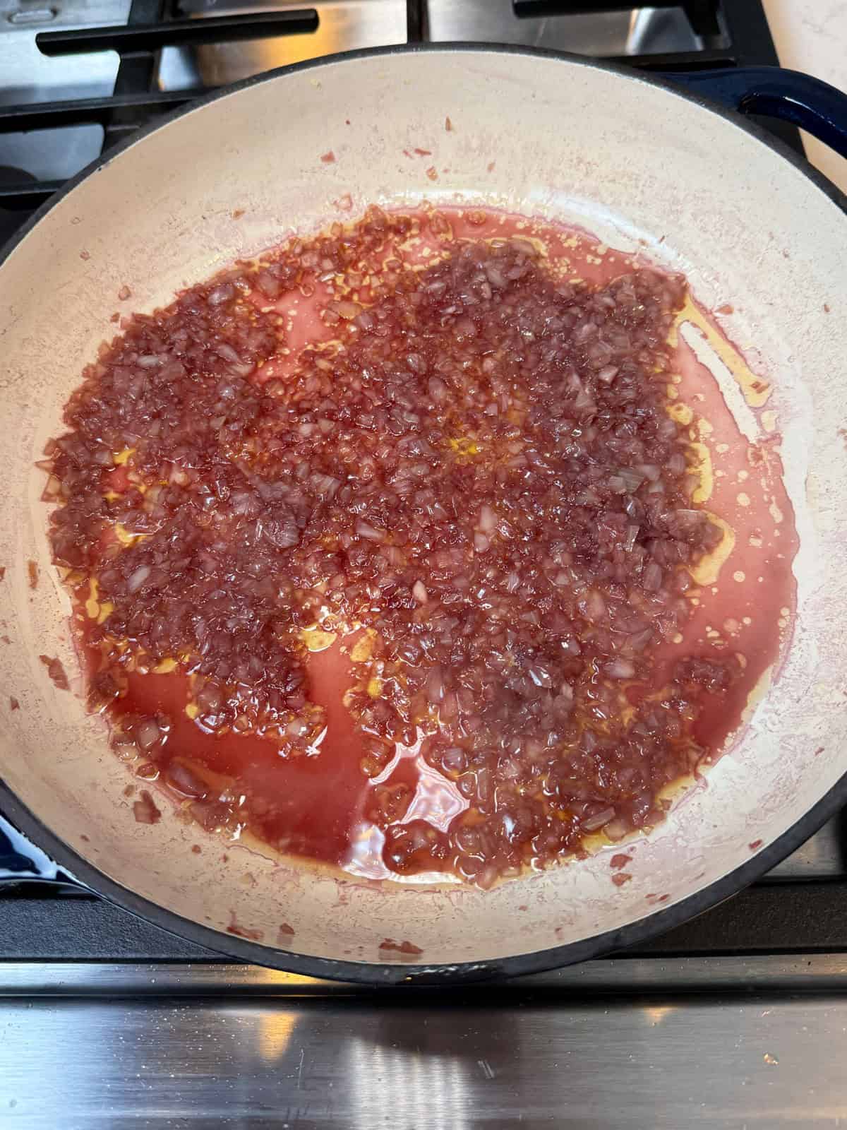 Once the chopped onions are sautéed, add red wine and let the wine reduce.