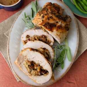 Roasted stuffed turkey breast filled with cranberry sausage stuffing and seasoned with
