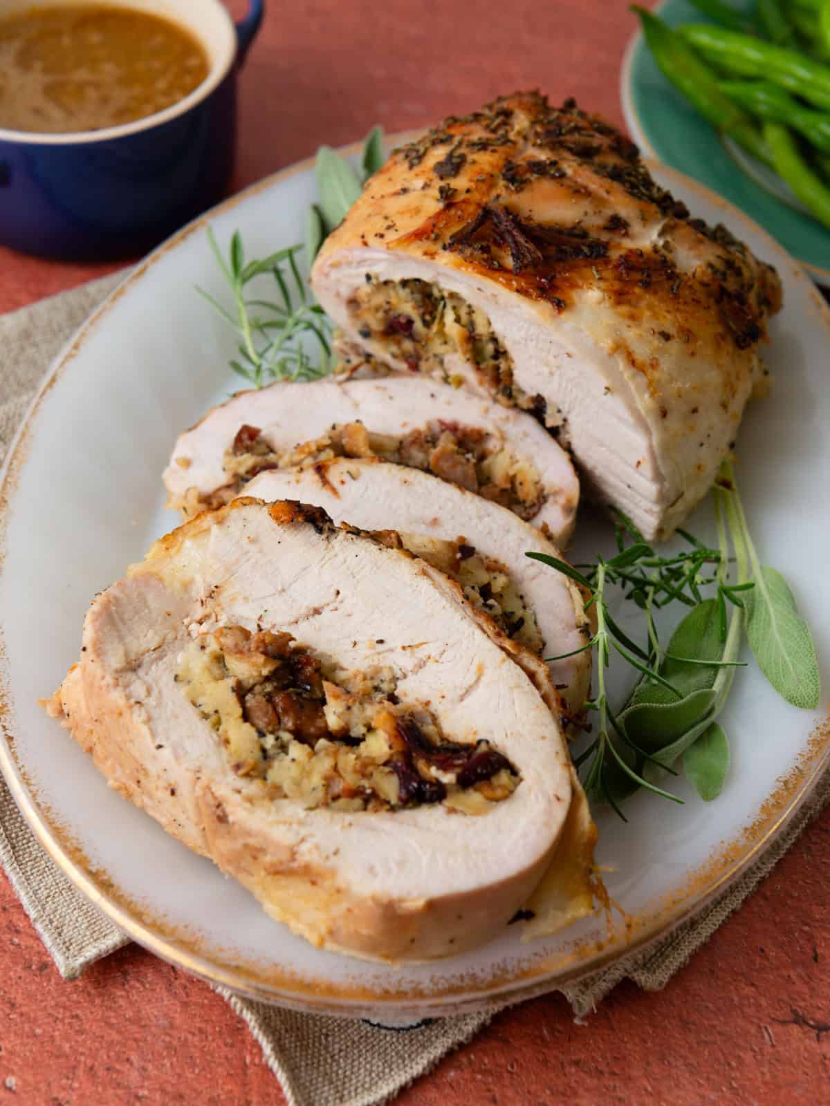 Roasted and stuffed turkey breast with stuffing and a flavorful compound butter.
