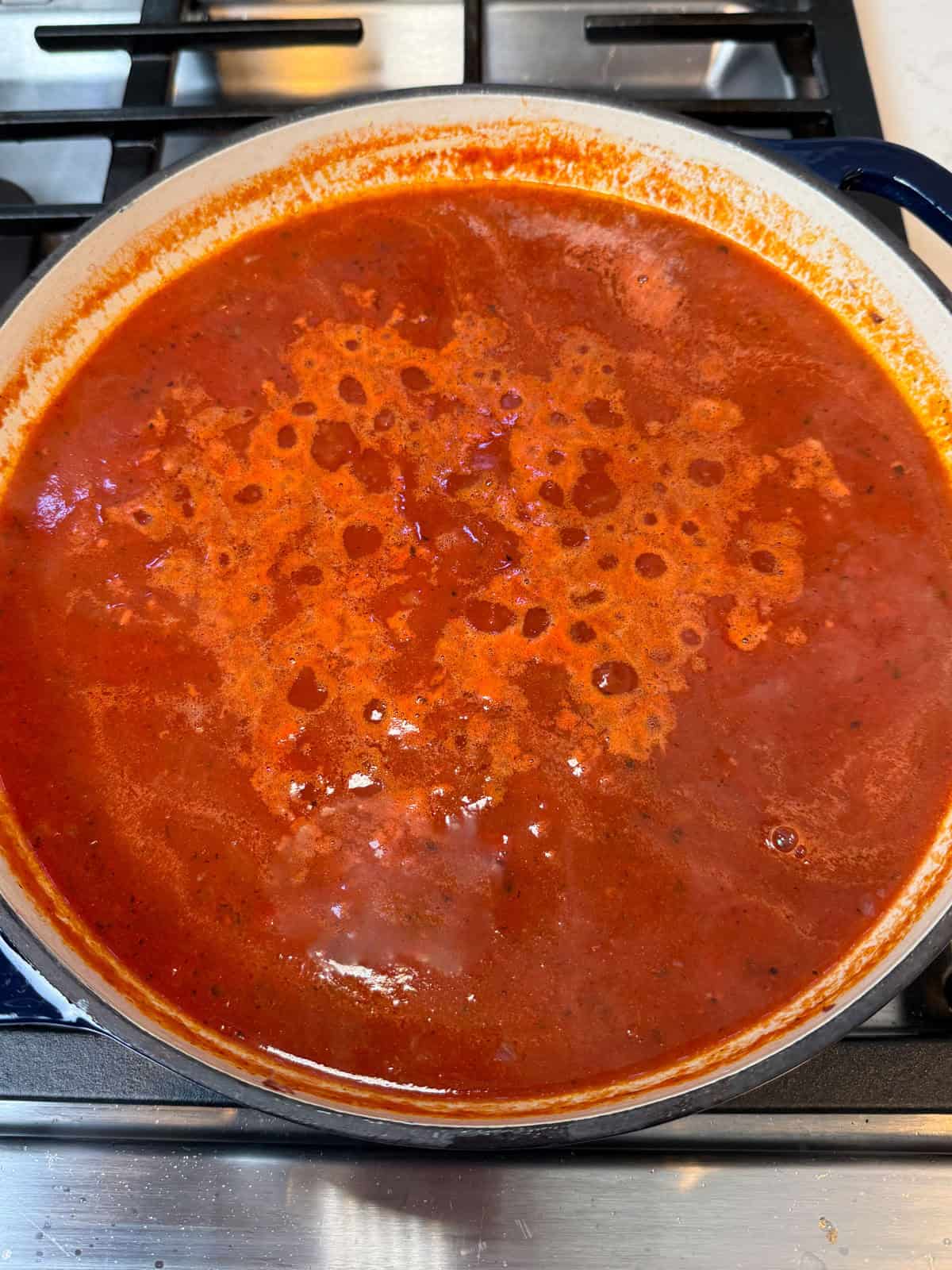 Simmer the sweet and sour tomato sauce for a few minutes before the meatballs are added.