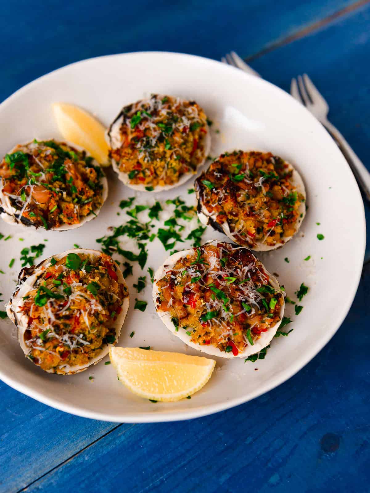 Baked clams casino are stuffed clams with a stuffing made up of clams, breadcrumbs, herbs, bell pepper and parmesan cheese.