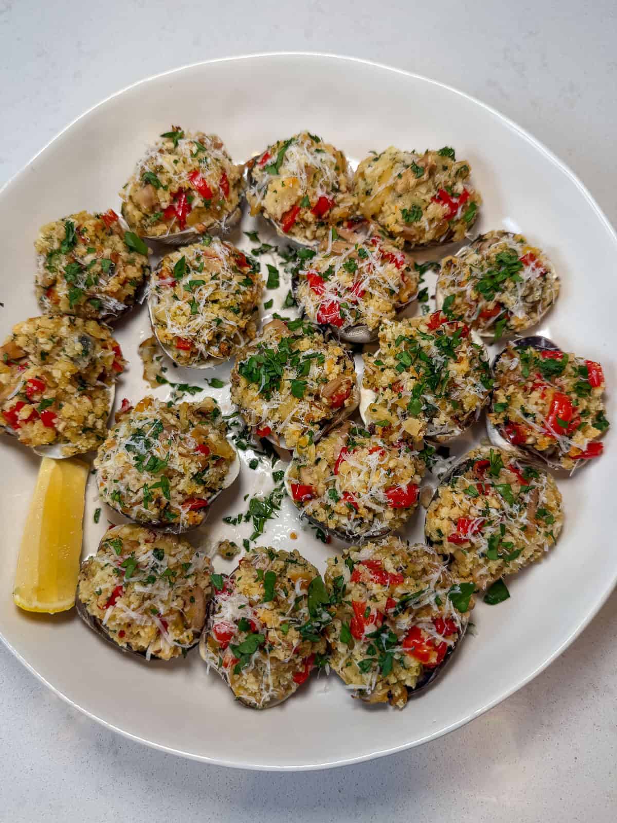 Serve the finished baked clams casino with fresh lemon wedges.