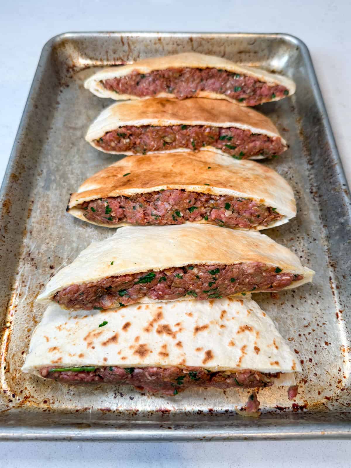 Fill the pita halves evenly with the ground beef mixture.