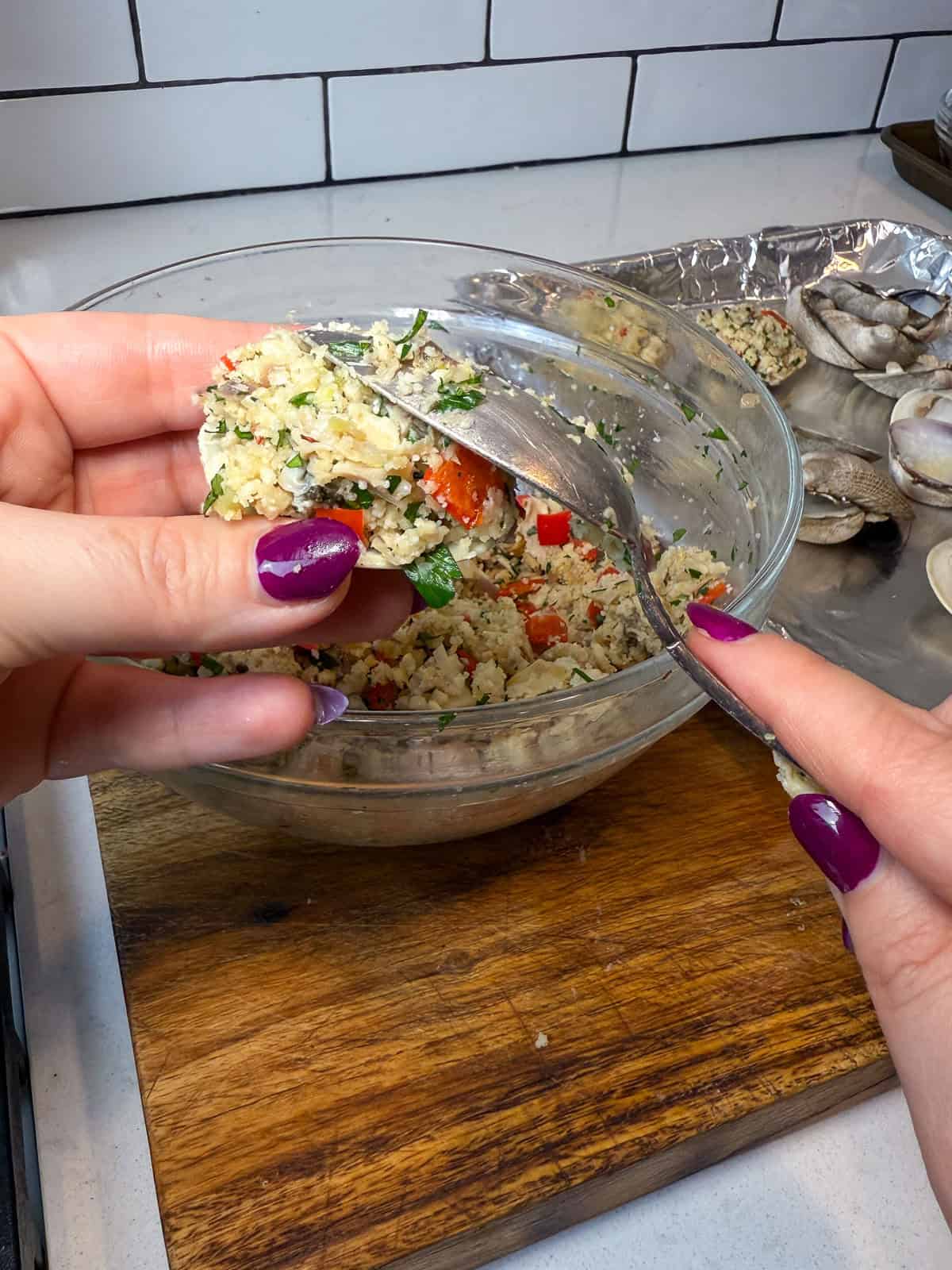 Use a tablespoon to stuff each halved clam shell with the clam mixture.