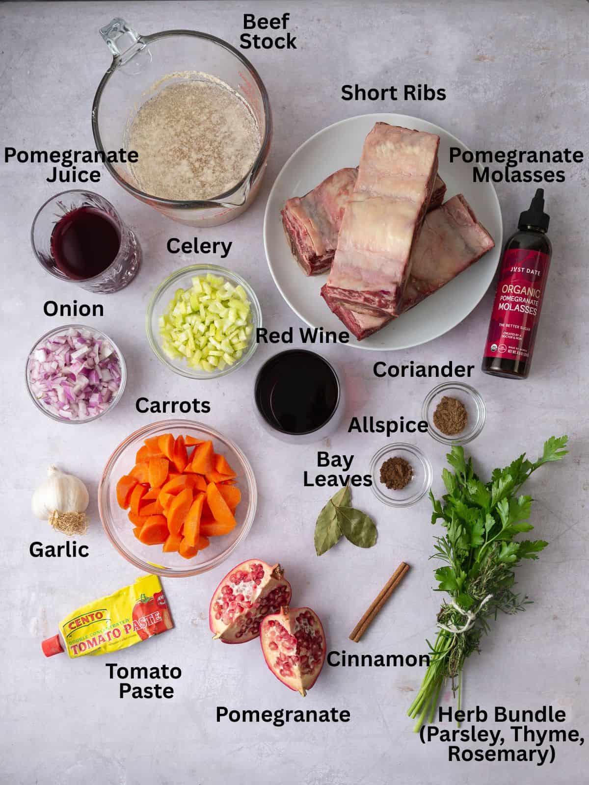 Ingredients for braised pomegranate short ribs, including pomegranate molasses, red wine, warm spices and fresh herbs.