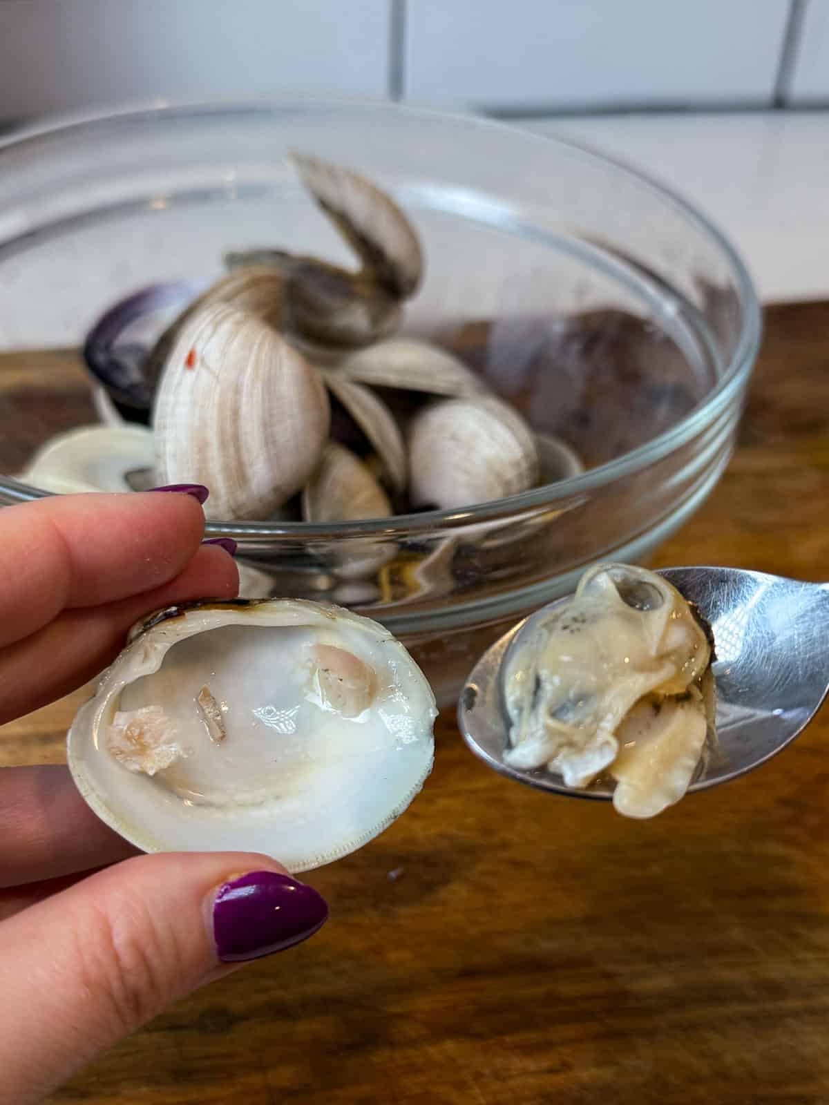 Once the clams are cooked, separate the clam halves and remove the cooked clam from the shell.