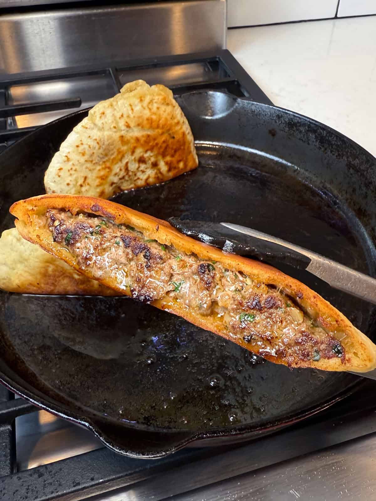 Once you cook the beef stuffed pitas, sear the ends so the meat and pita adhere.
