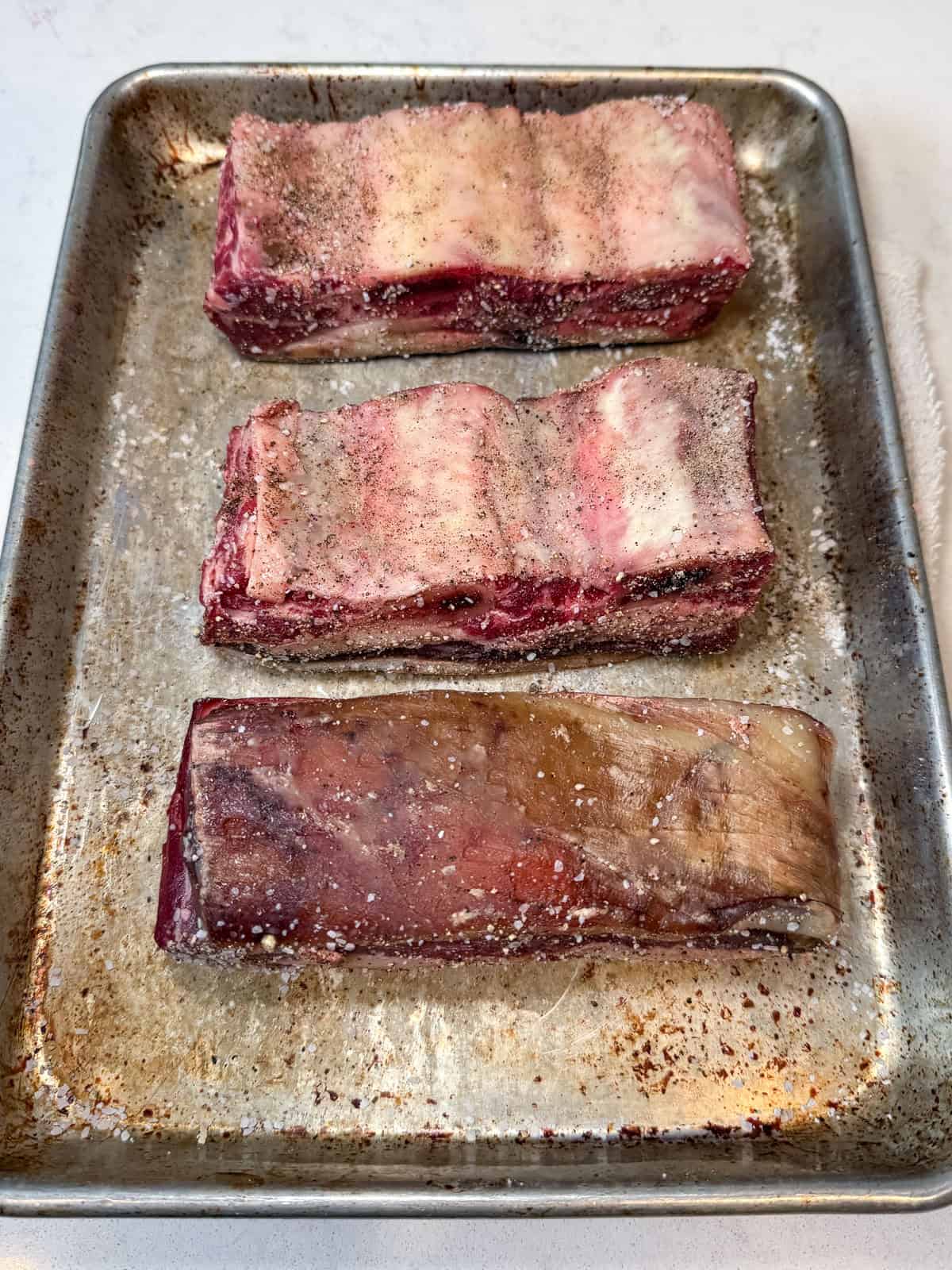 Pat the short ribs dry and season with salt and pepper on all sides.