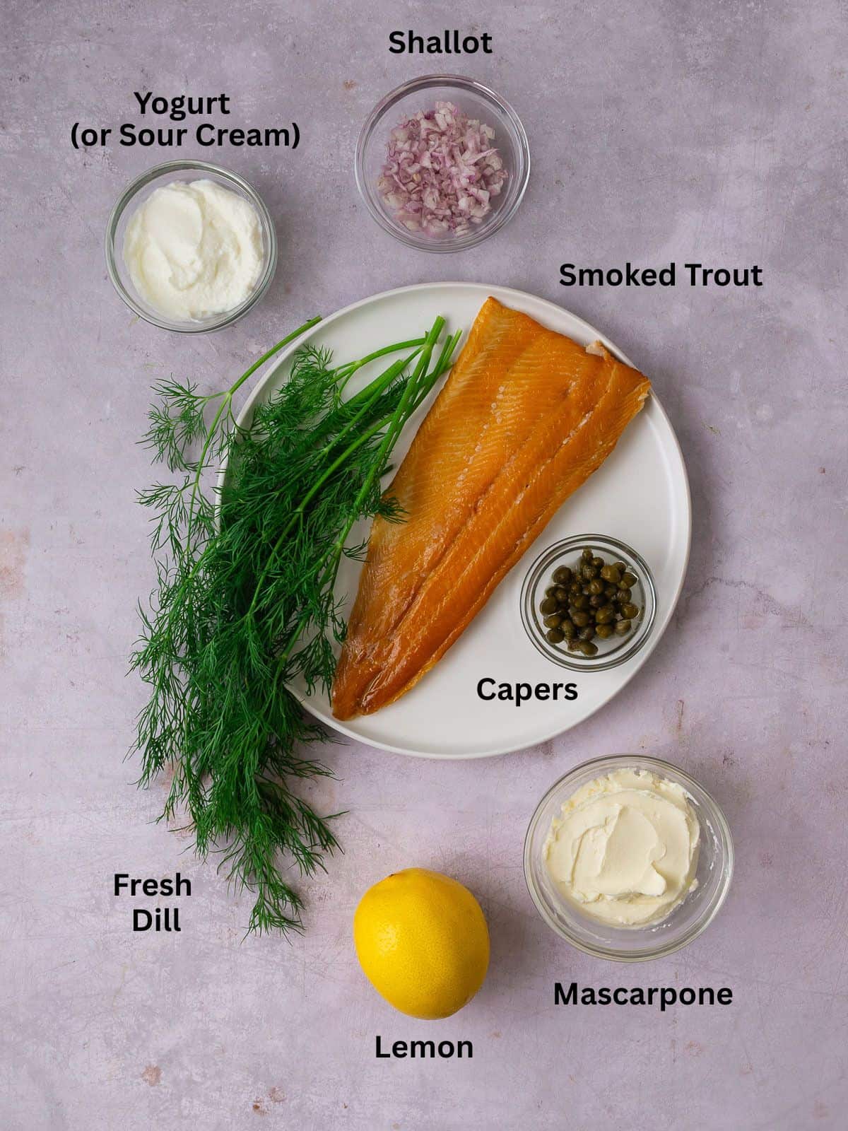 Ingredients for smoked trout dip including lemon, fresh dill, shallot and mascarpone.