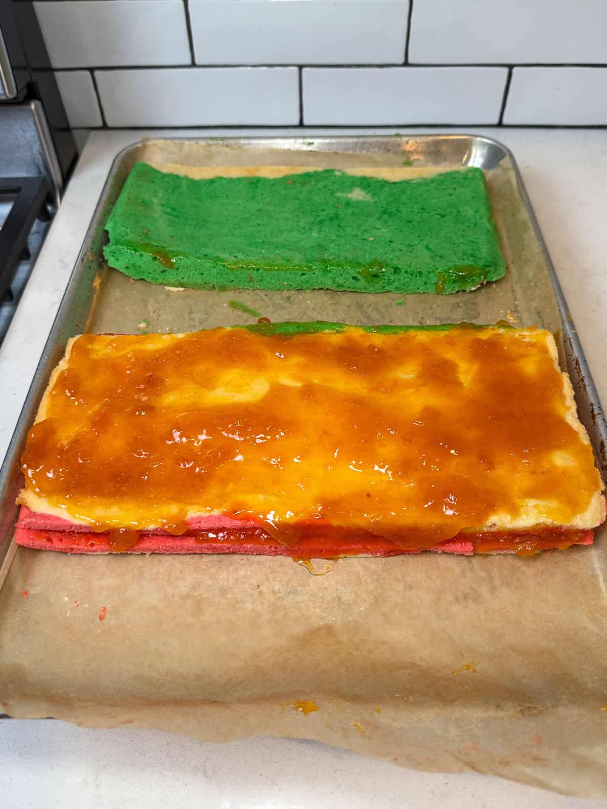 Spread a thin layer of apricot jam on the white/yellow layer.