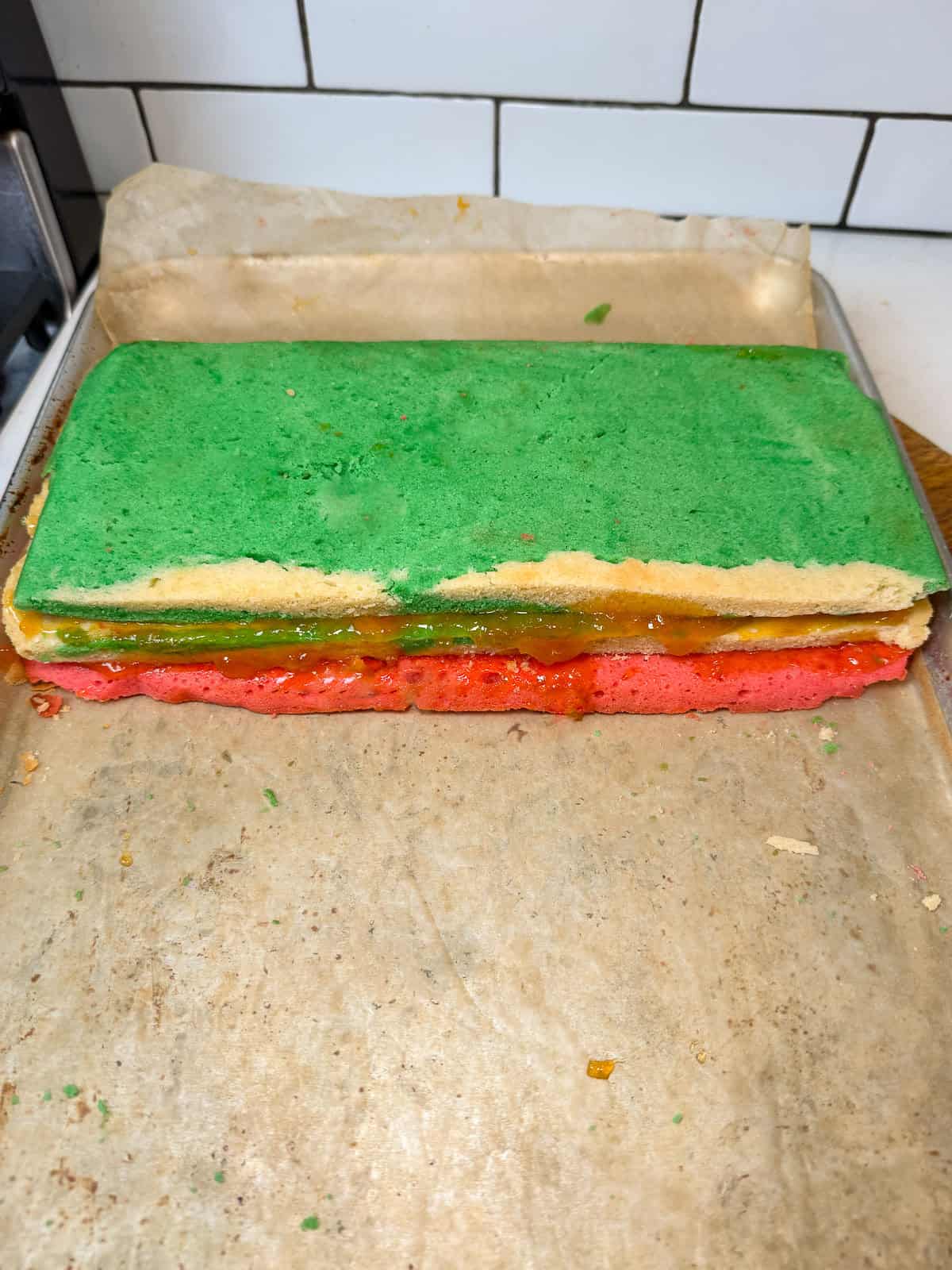 Stack the green layer of the rainbow cookie on top.