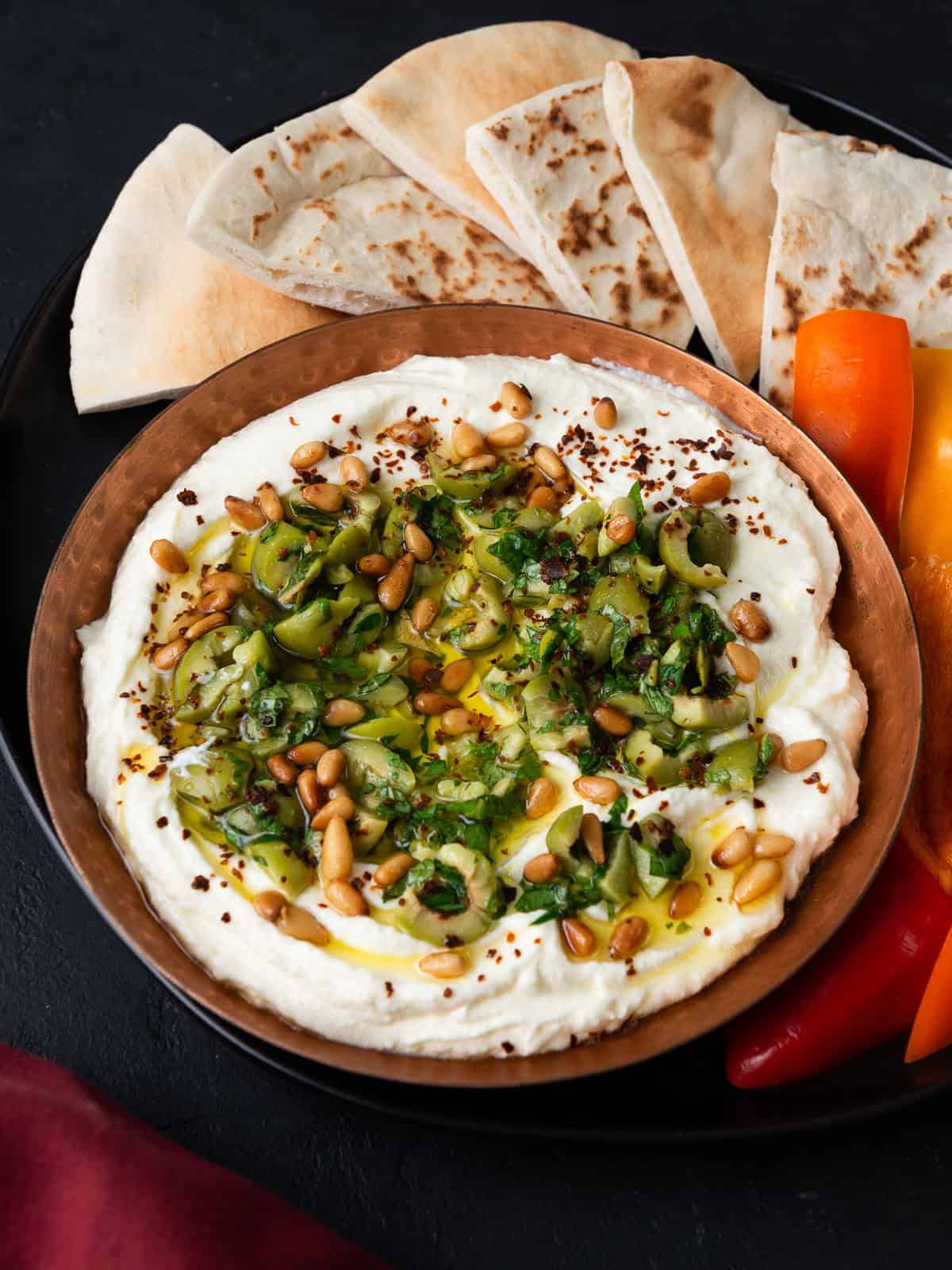 Creamy whipped feta cheese toped with marinated olives and toasted pine nuts.