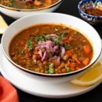 This vegan Moroccan lentil soup is full of bold spices, hearty lentils and tender vegetables. Garnish with lemon and a drizzle of olive oil.