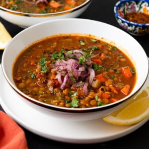 This vegan Moroccan lentil soup is full of bold spices, hearty lentils and tender vegetables. Garnish with lemon and a drizzle of olive oil.