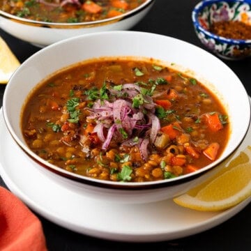 This vegan Moroccan lentil soup is full of bold spices, hearty lentils and tender vegetables. Garnish with lemon and a drizzle of olive oil.