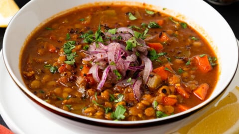 This vegan Moroccan lentil soup is full of bold spices, hearty lentils and tender vegetables. Garnish with lemon and a drizzle of olive oil.