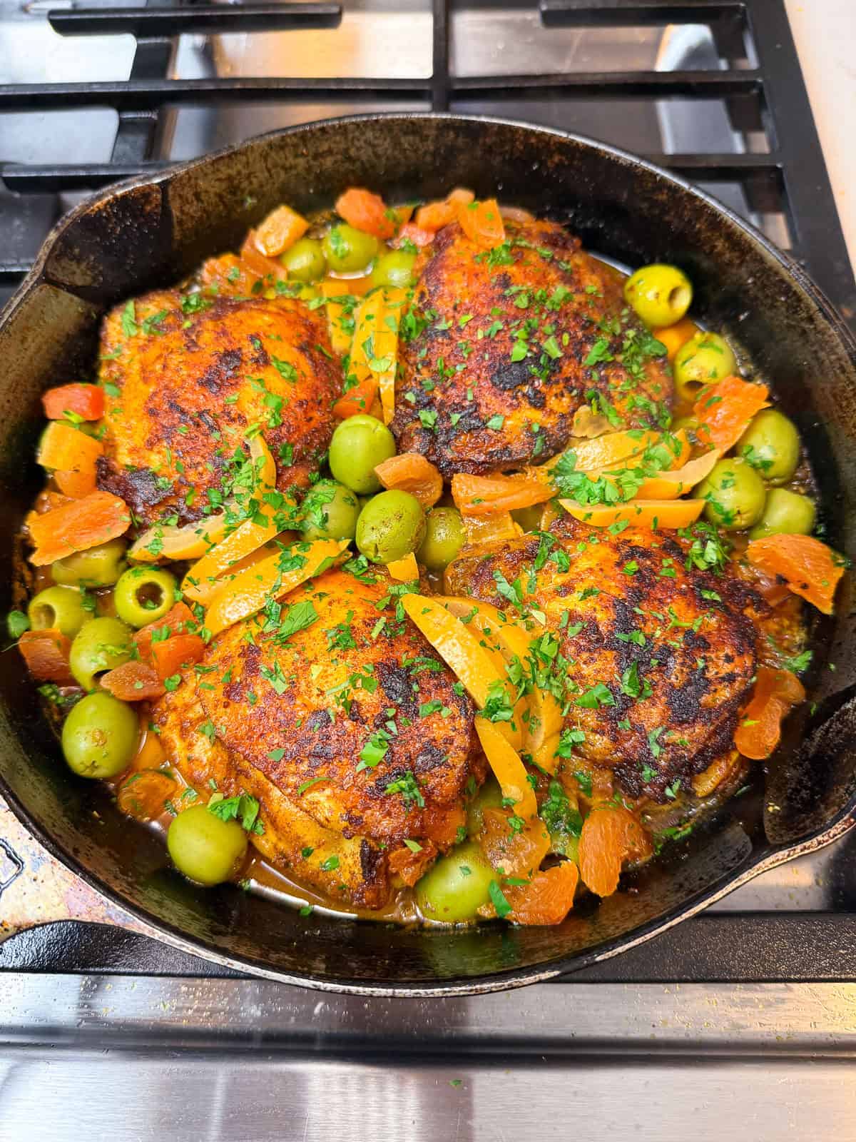 Add the olives and dried apricots during the last few minutes of cooking the chicken tagine. Garnish with parsley.