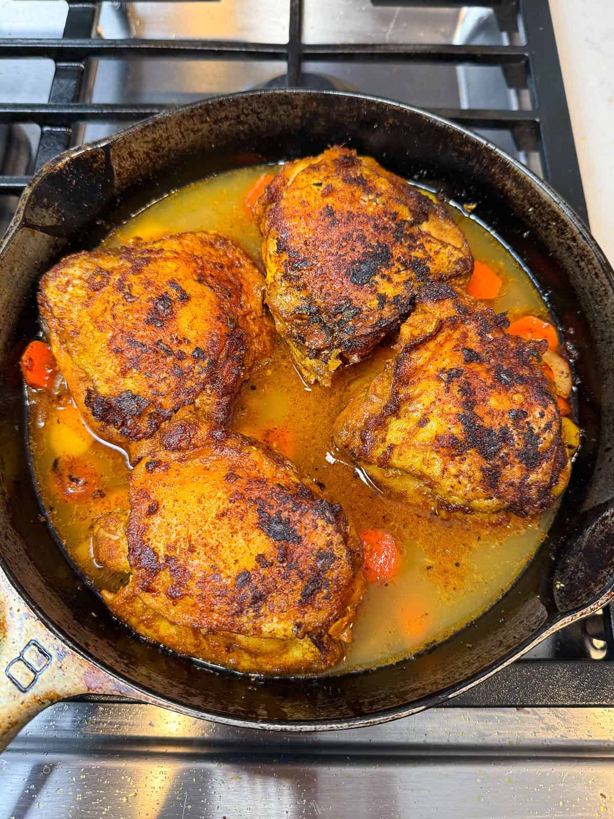 Add the seared chicken to the sautéed vegetables and pour the preserved lemon and chicken stock mixture around the chicken.