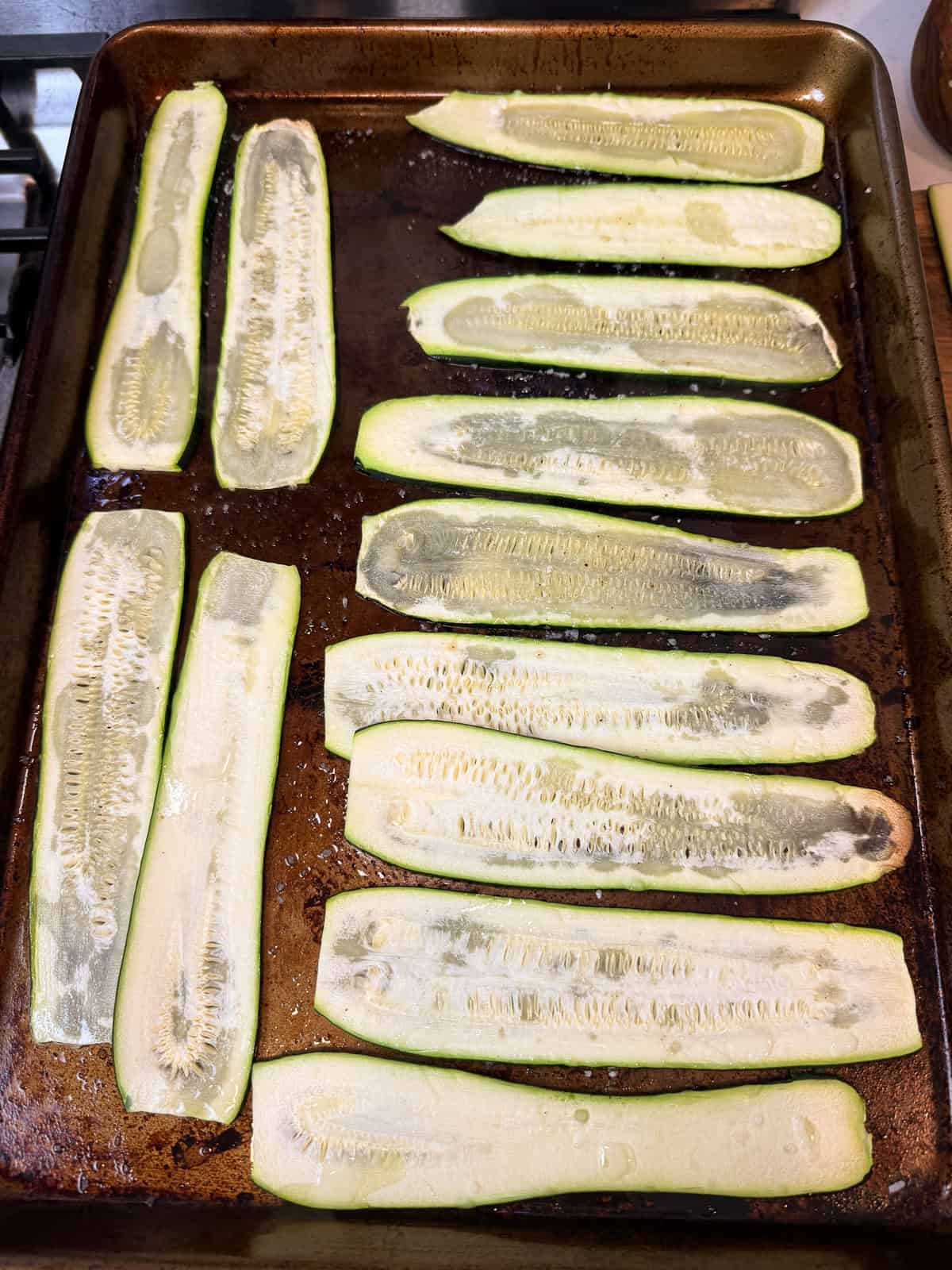 Bake the zucchini slices for 10 minutes until they are pliable and slightly roasted.