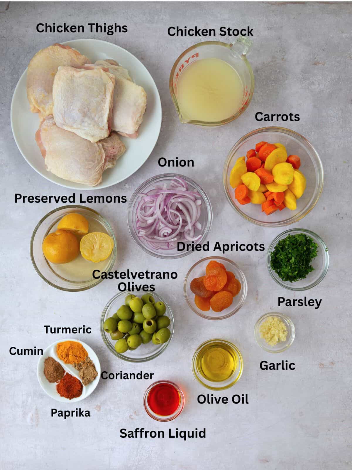 Ingredients for chicken tagine including preserved lemons, olives, dried apricots and spices.