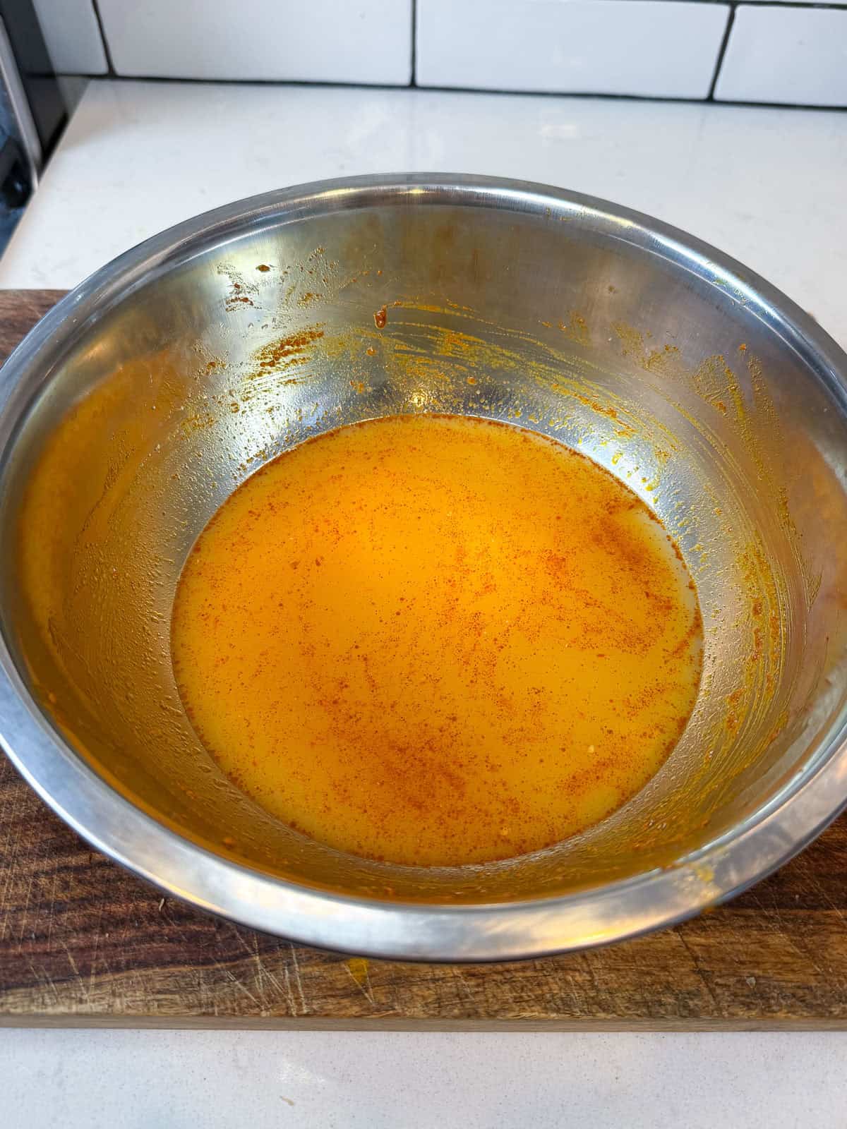 Make the tagine braising liquid and add the chicken stock, preserved lemon juice to a bowl and stir to combine.