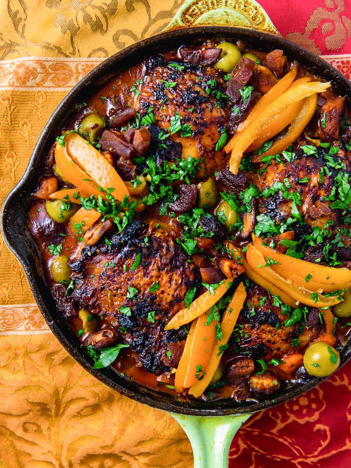 Chicken tagine with preserved lemons, olives, dried apricots and flavored with bold spices.