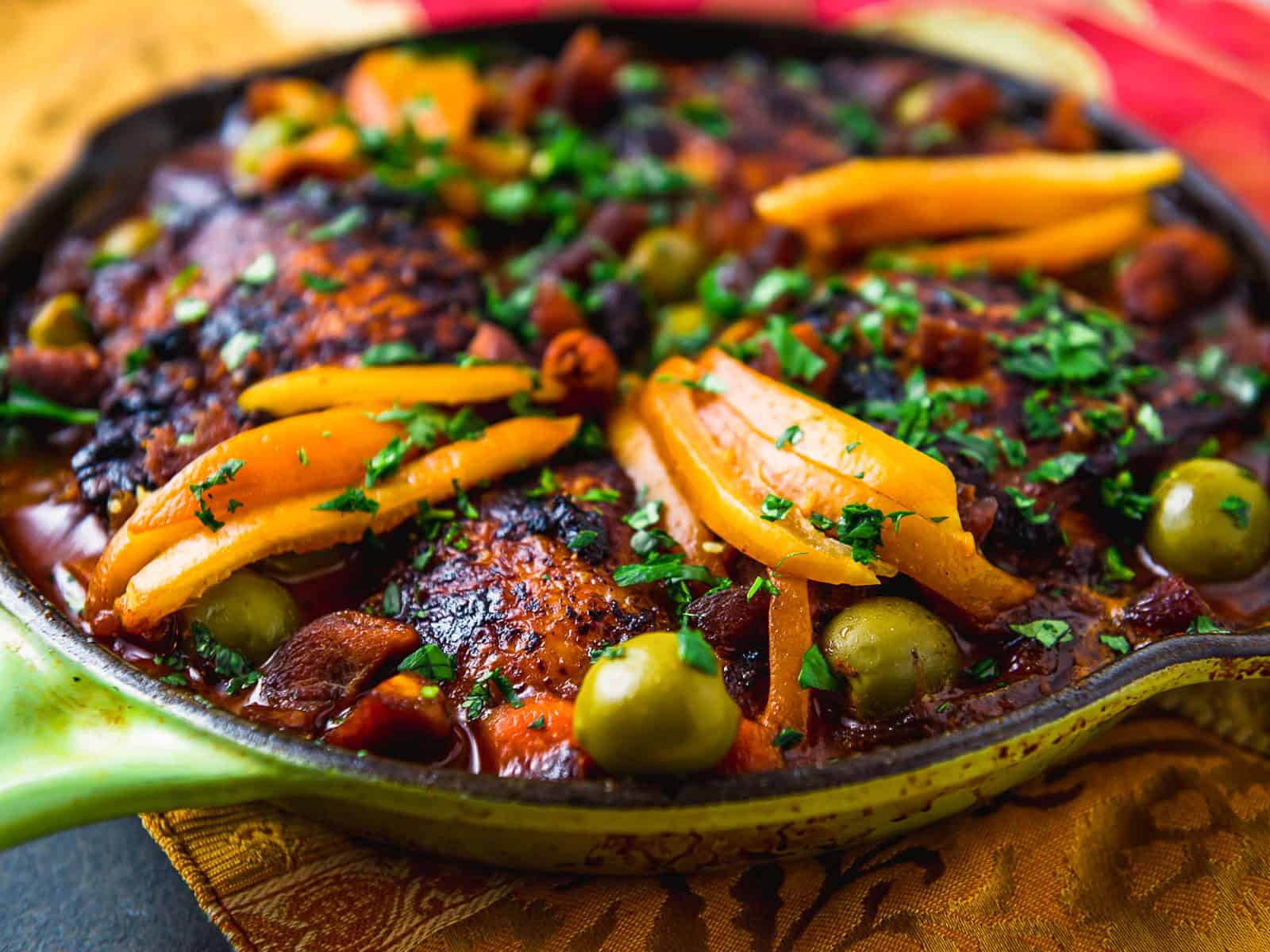 Weeknight chicken tagine recipe with olives, preserved lemons, dried apricots and warm spices.
