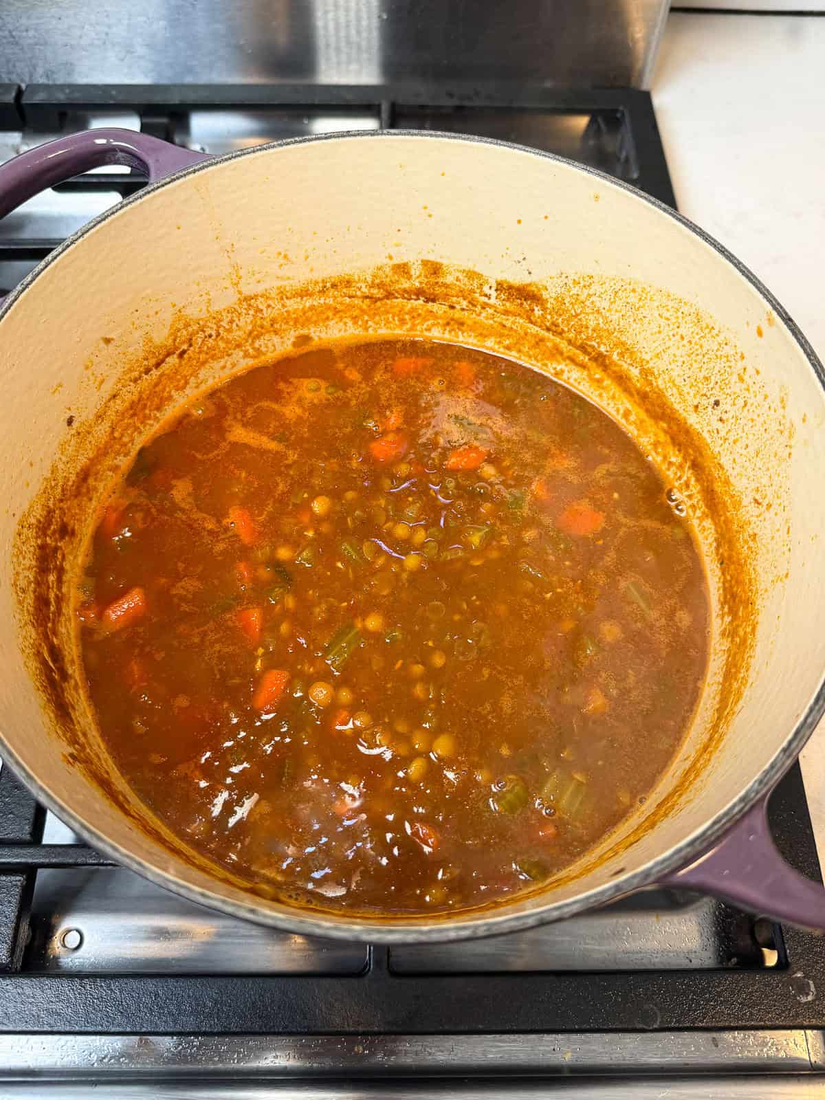 Continue simmering the Moroccan lentil soup until the lentils are tender and the soup has thickened.