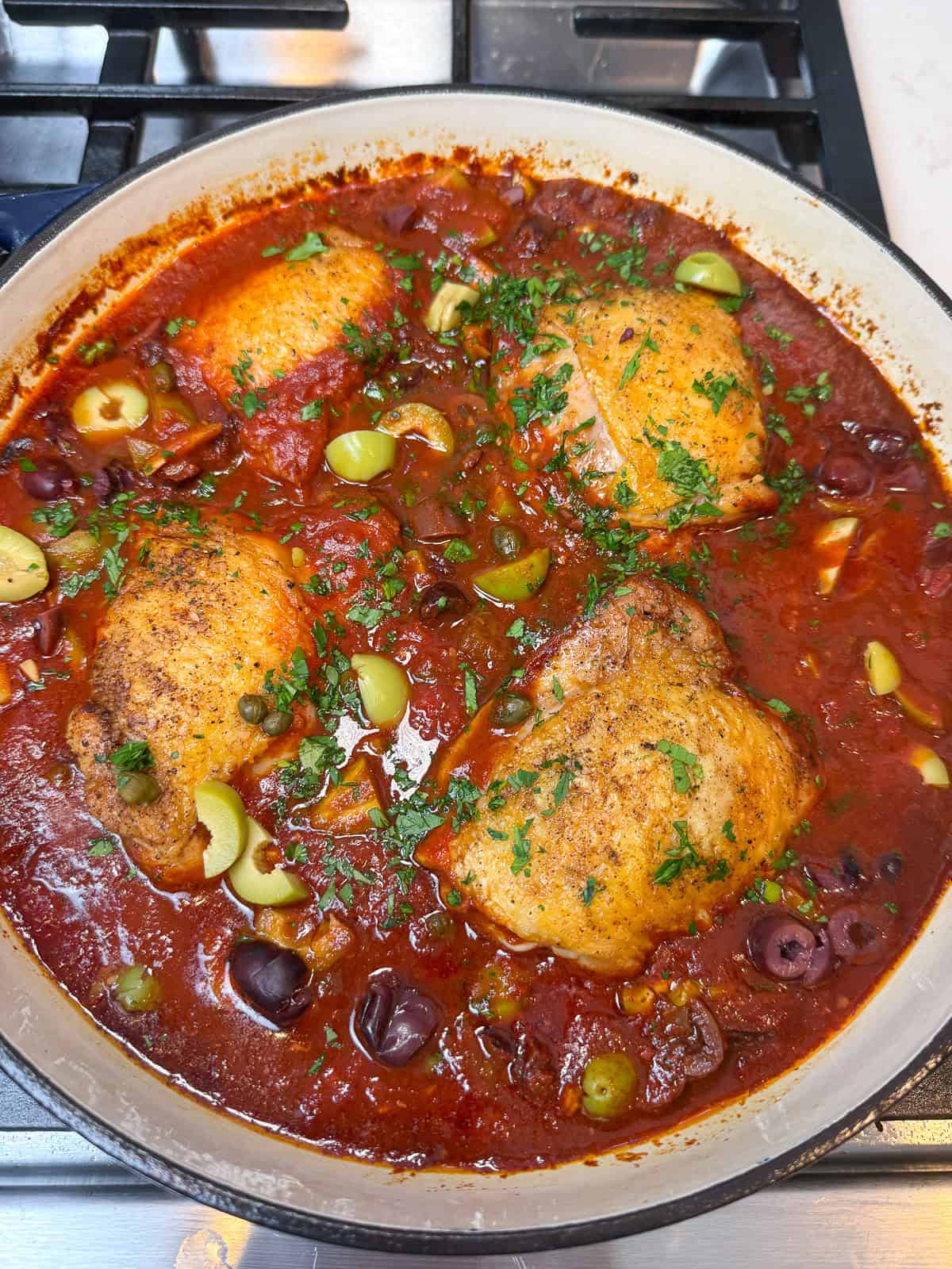Simmer the puttanesca until sauce has reduced slightly and chicken is cooked through.