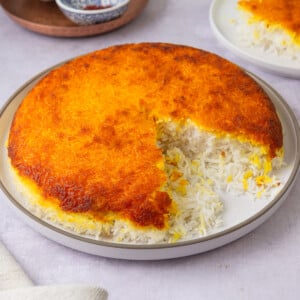 This crispy Persian rice is called tahdig and is made with fragrant basmati rice and has a layer of crispy rice that's flavored with saffron and turmeric.