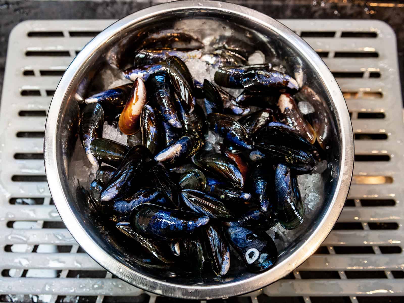 Keep the cleaned mussels in a bowl full of ice until you are ready to cook them.