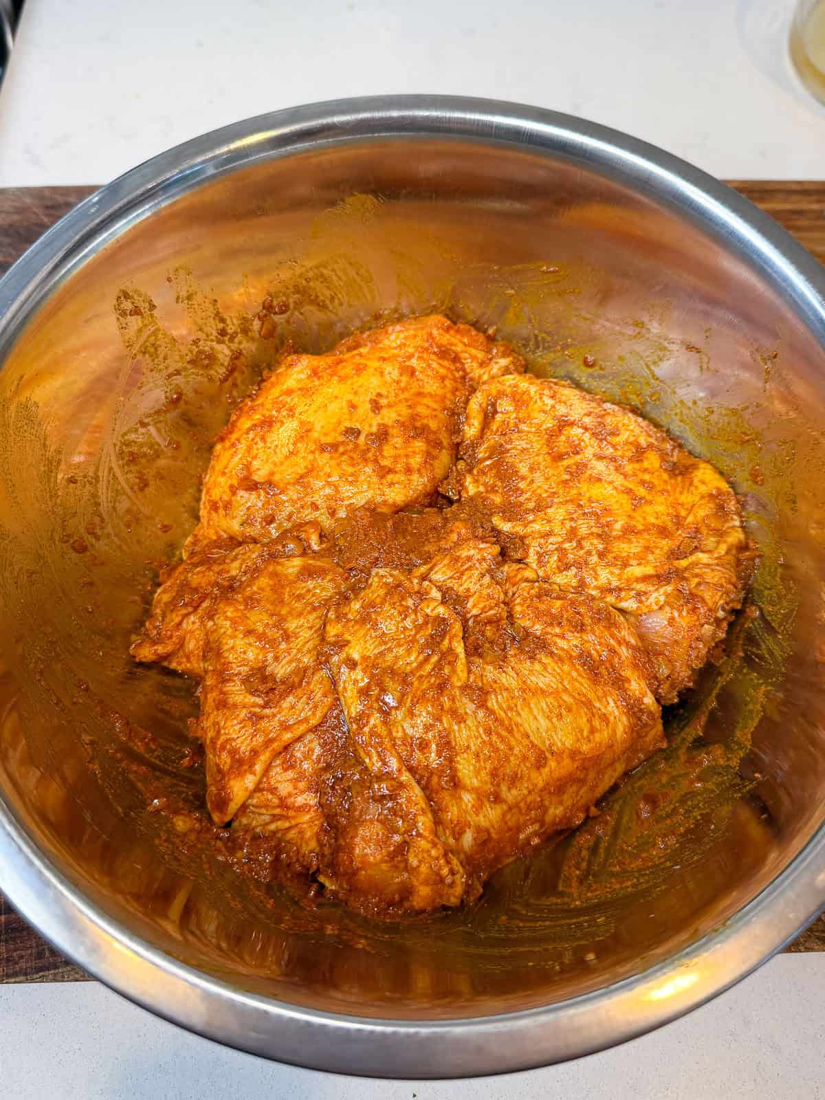 Marinate the chicken thighs with chopped preserved lemon, spices, olive oil and garlic toss to coat the chicken well.