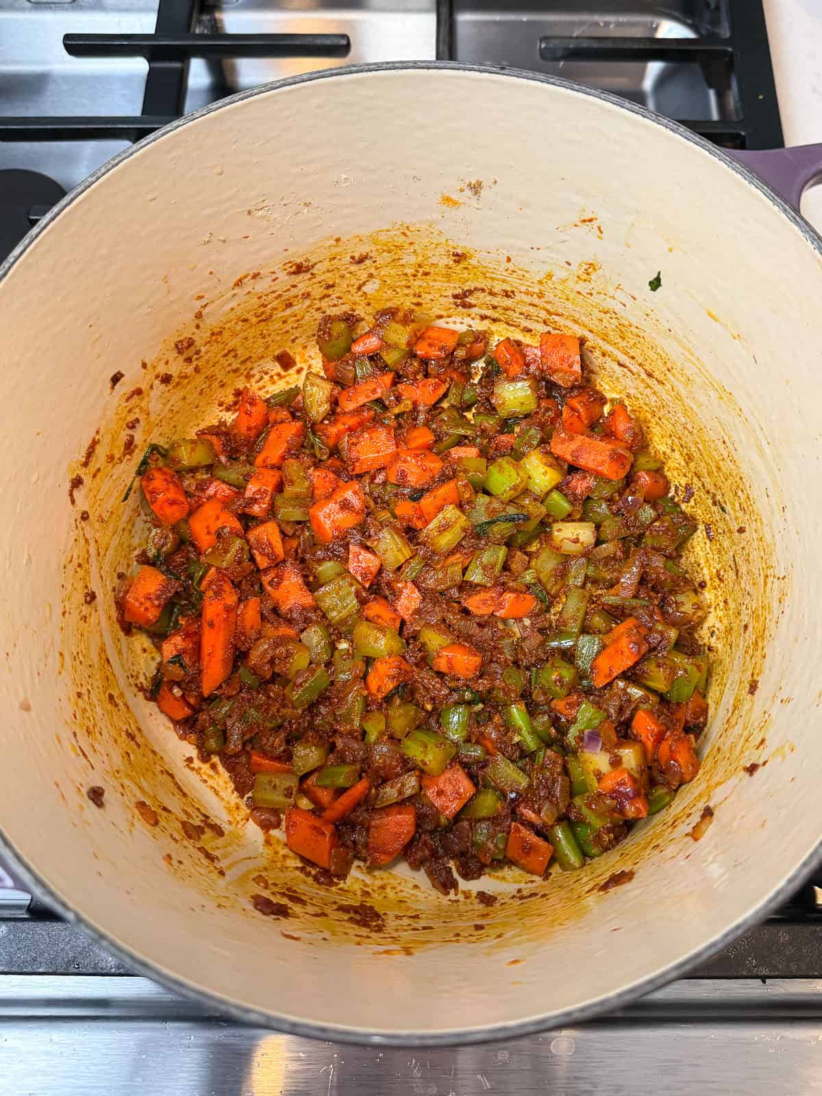 Saute the warm spices with the vegetables as the base of the lentil soup.