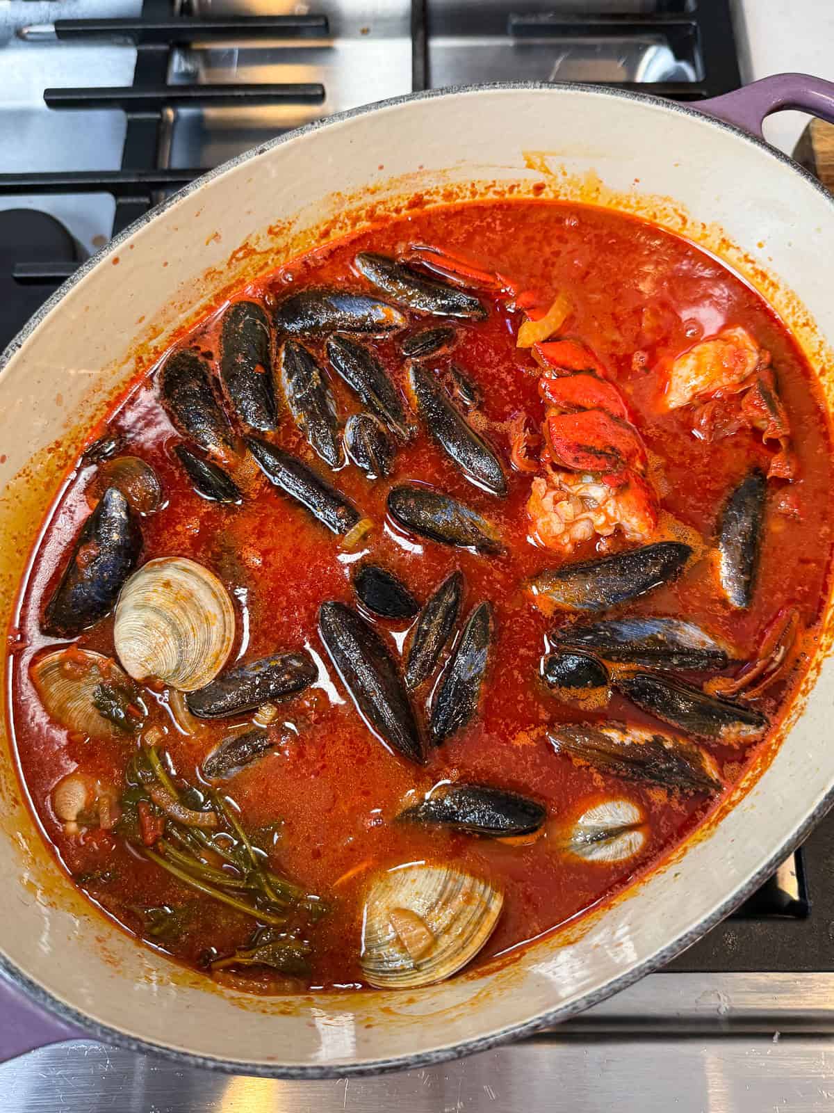 Layer the mussels and clams into the cioppino after you add the lobster tails.