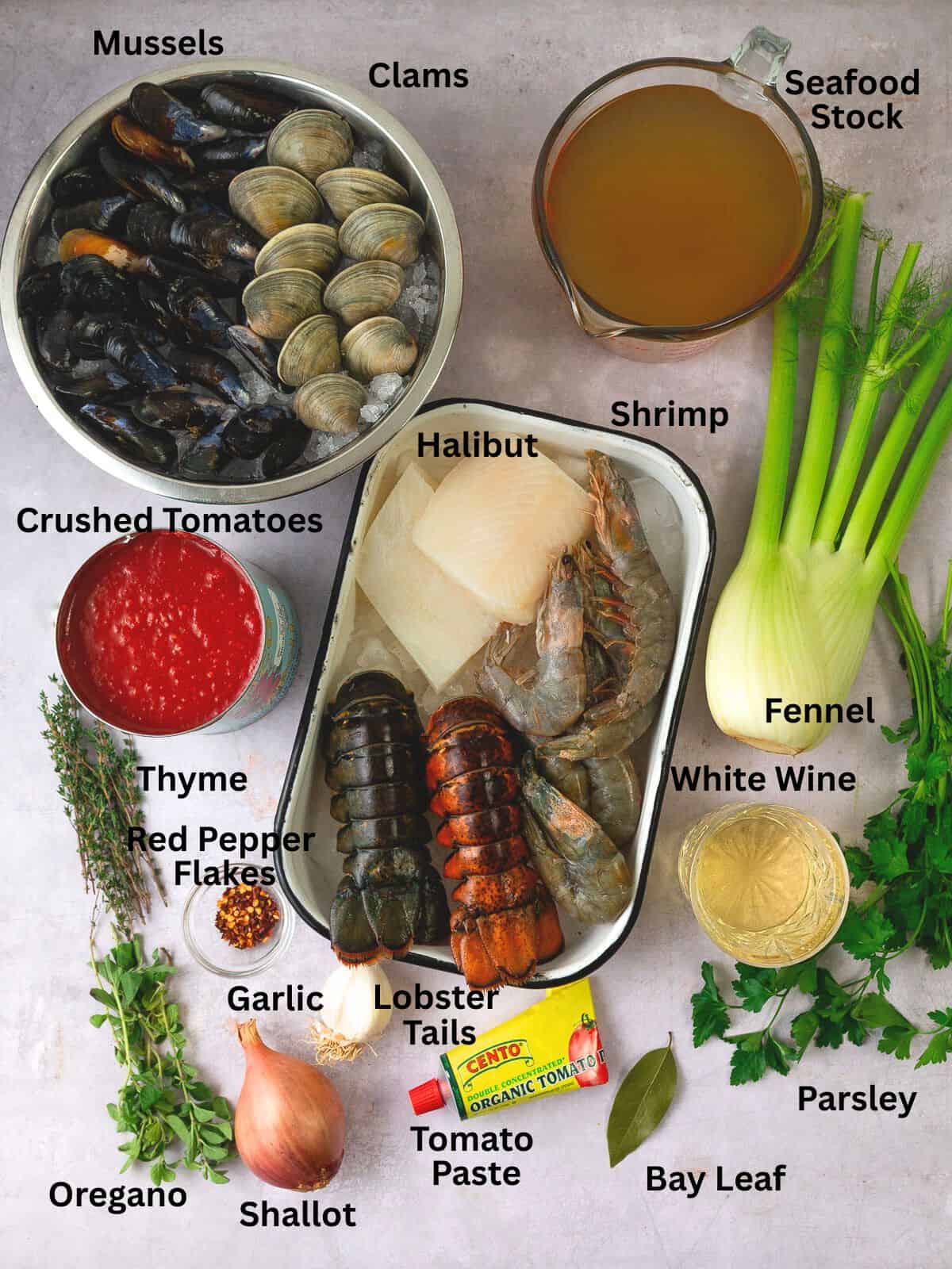 Cioppino ingredients including fennel, white wine, halibut, clams and mussels, crushed tomatoes and aromatics.