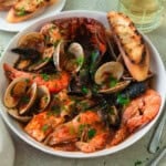 This cioppino recipe is full of abundant seafood with clams, mussels and lobster in a flavorful tomato broth.