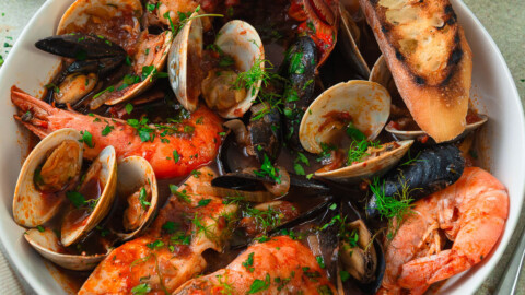 This cioppino recipe is full of abundant seafood with clams, mussels and lobster in a flavorful tomato broth.