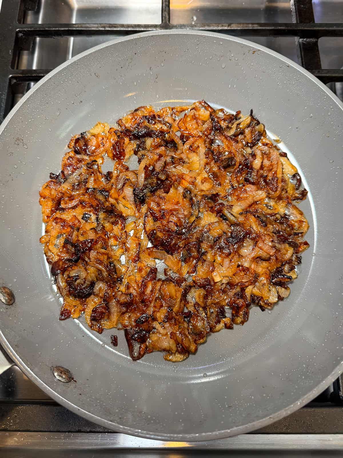 Fry the4 sliced onions until they are deeply browned and gently fried on the edges.